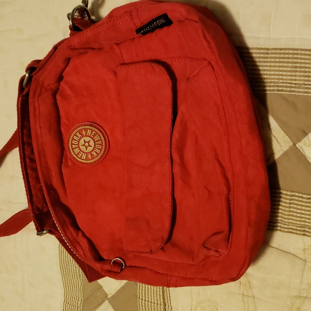 Great condition. Zip close front and back. Front also velcro pocket. Great buy
